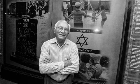 Morris Bendit in front of the memorial he designed