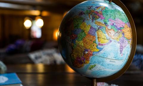 A globe of the world sits atop a table.