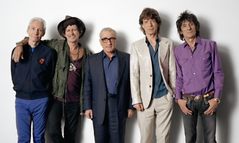 Bandmates from The Rolling Stones pose in front of a white backdrop.