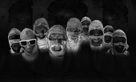 A striking group portrait features the mysterious mummies displaying their eerie, bandaged faces against a dramatic black backdrop.