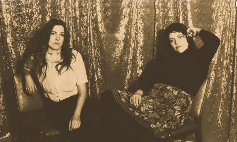 The duo Mama's Broke depicted in front of a shiny curtain in a tintype style