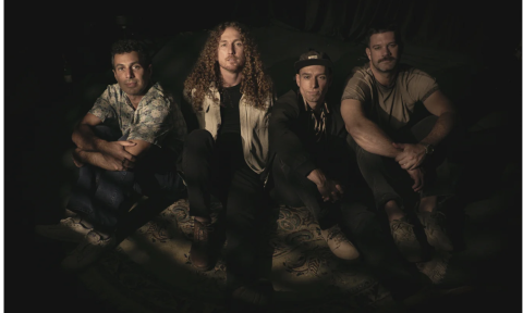 Bandmates from Honey Hounds pose in front of a black backdrop.