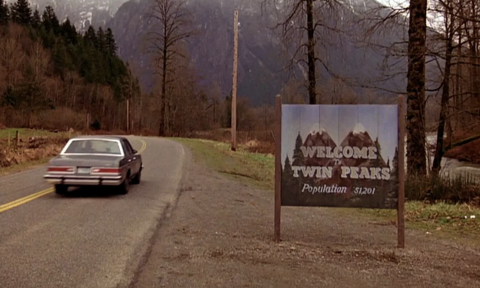 A car speeds past a Twin Peaks billboard.