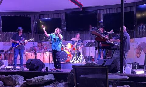 Bandmates from Ultimate Santana performs live on stage.