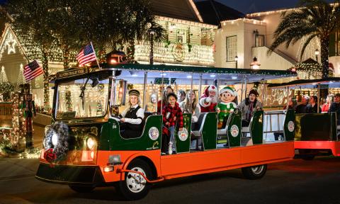 An Old Town Trolley decorated for Nights of Lights with special guests aboard, inluding Santa
