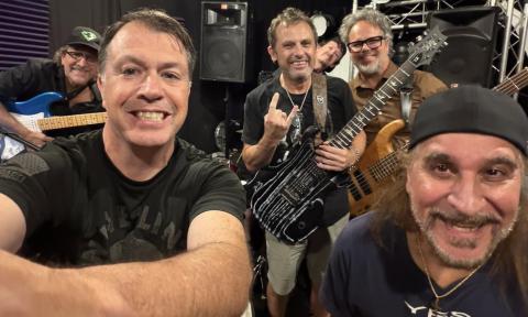Bandmates from Matchbox Down pose in a music studio.