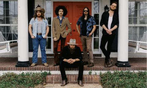 Bandmates from Robert Jon & The Wreck pose on a deck with white pillars.