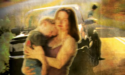 Amy McGee holding her child in the film poster