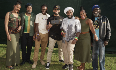 Bandmates from The Wailers pose on a freshly cut lawn.