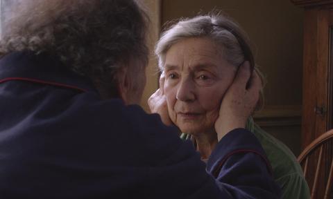 Georges holding Anne's face in the film "Amour"
