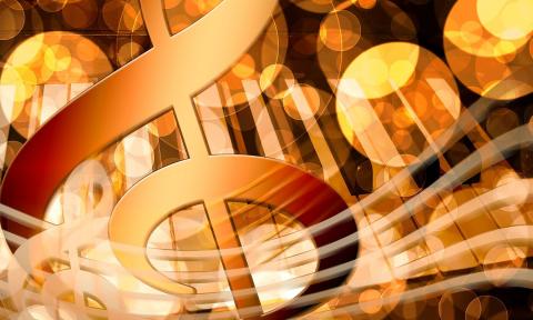 A graphic featuring a g-clef, musical notes, and a staff all in gold.
