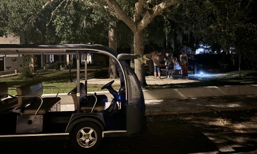 The Land & Sea Ghost Tours EV with guests gathering at the plaza