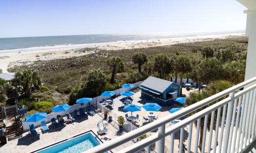 The Tiki Bar and the beach viewed from an upper deck at Guy Harvey Resort