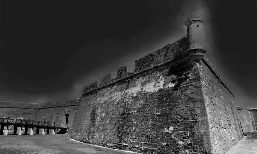 An eerie black and white photo of the Castillo de San Marcos in St. Augustine, Florida