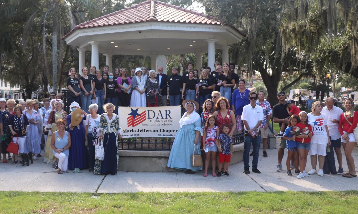 A gathering of local members of the Daughters of American Revolution, some in period costume, staged on and around the Gazebo in St. Augustine.