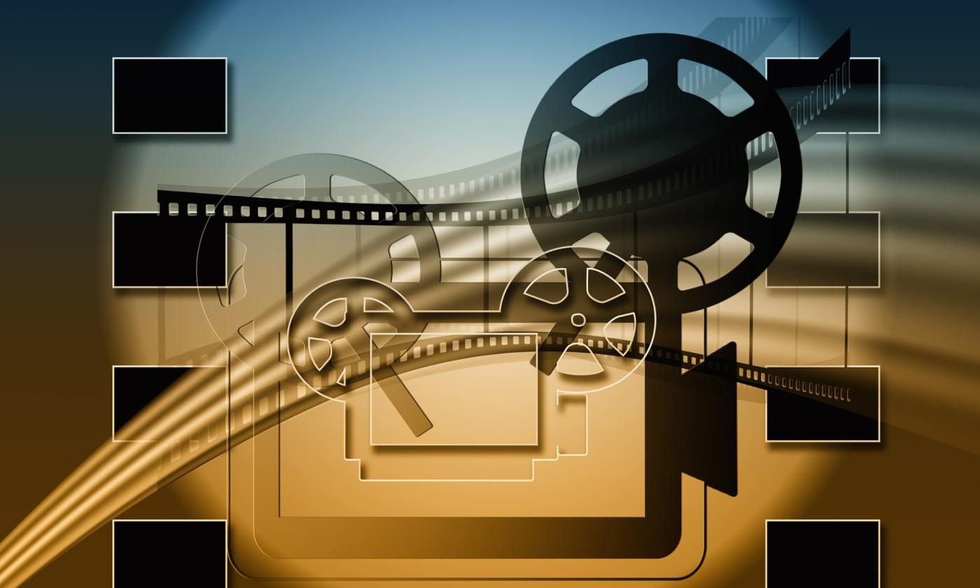 An artistic depiction of a movie camera and reel.