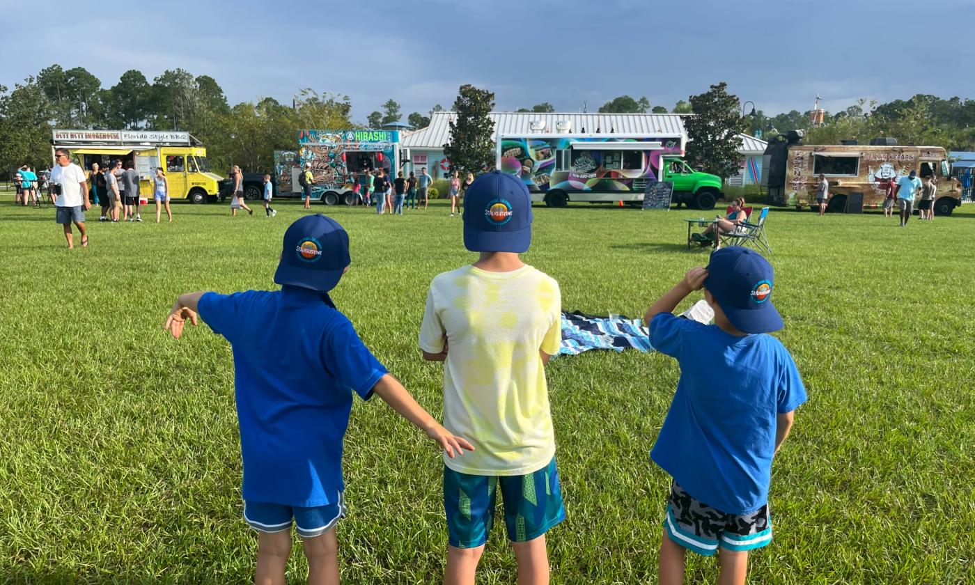 Boys wearing Visit St. Augustine hats at the Nocatee Food Truck Friday event 