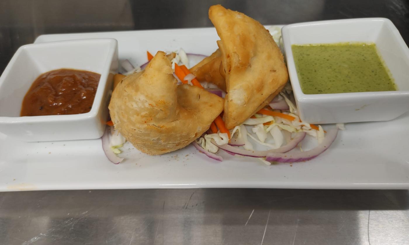 Samosa platter with red and green sauce