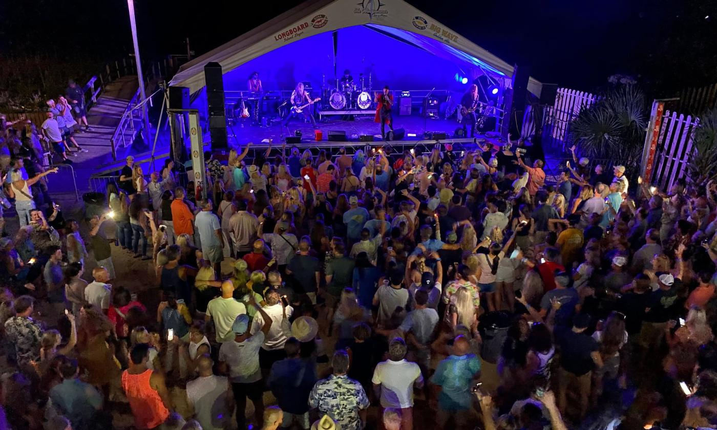 Departure Journey tribute band on stage in front of a crowd.