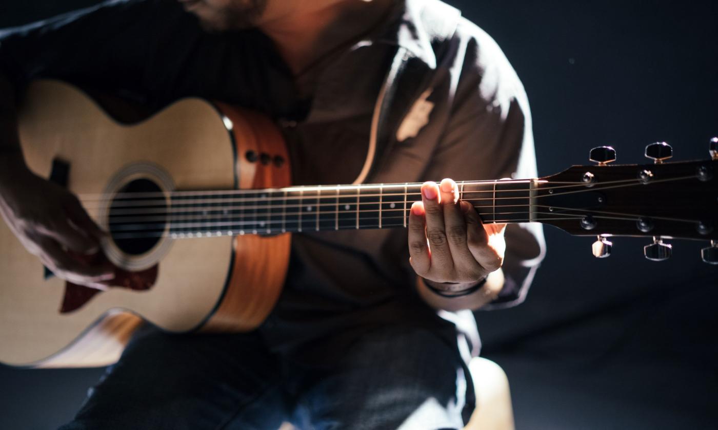 A man plays his guitar.