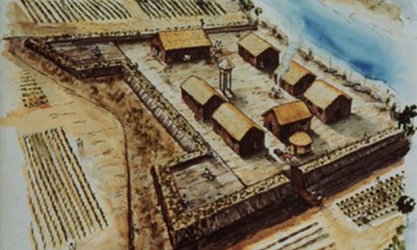 An artist's interpretation of what Fort Mose might have looked like in 1738. It is a wooden military fortification with several buildings within the walls. A marsh river flows in the background of the drawing. 