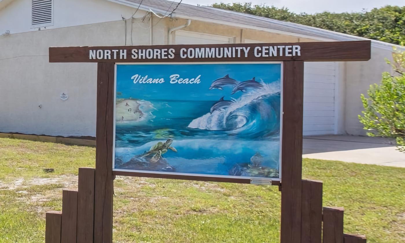 The sign at the North Shores Community Center in Vilano Beach features a painting of the ocean with dolphins