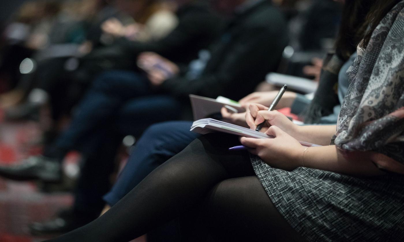 A group of people rally at a forum on government. 