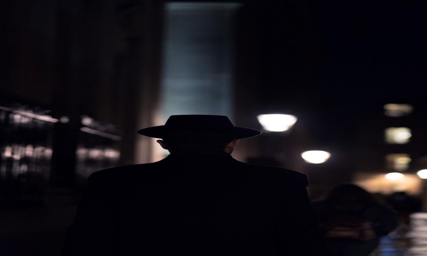 A man walks at night.