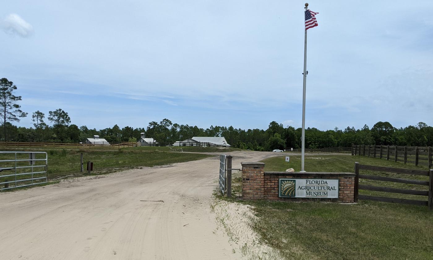 An American flag sways next to the opening of the Florida Agricultural Museum.