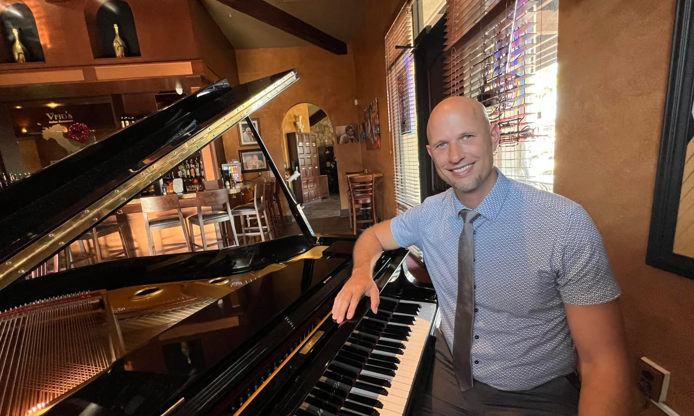 Pianist Jeremy Weinglass seated in front of the piano. 