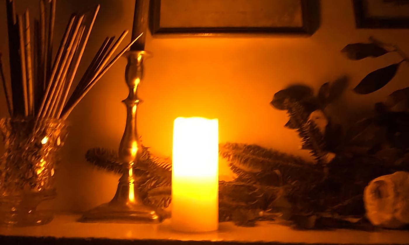 A candle set on a table in an old museum