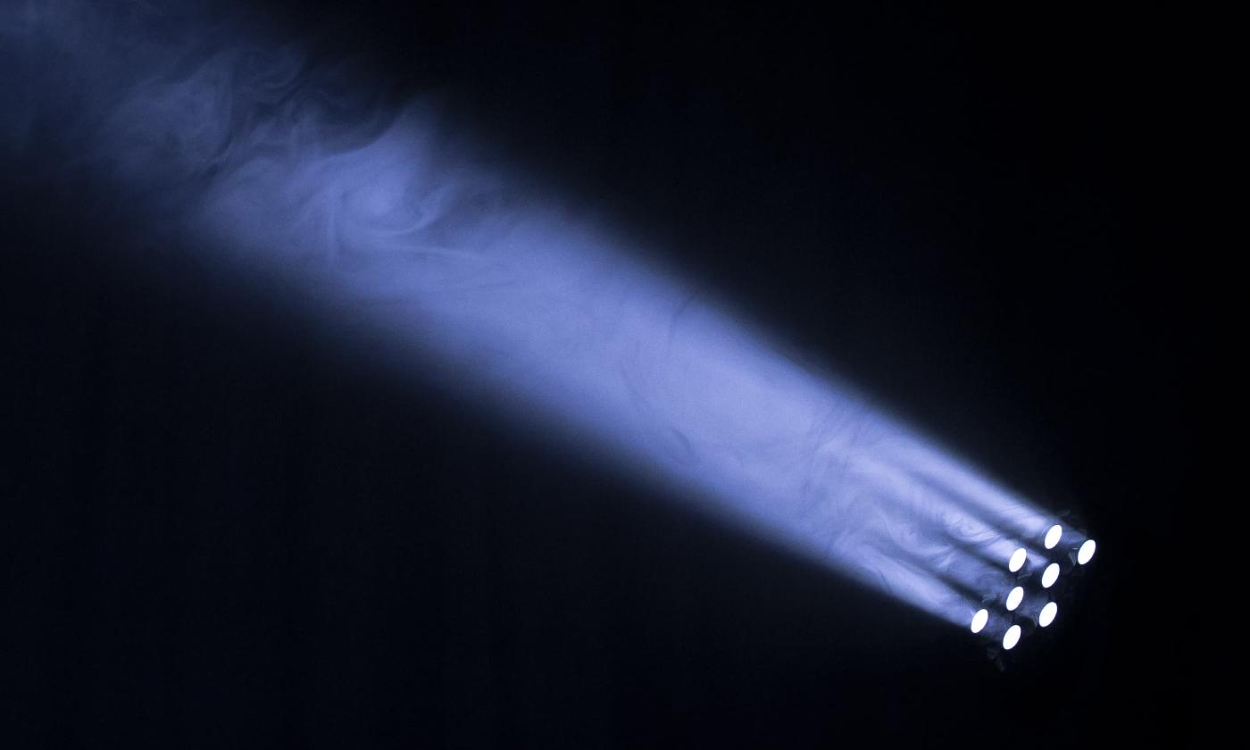 Theatre lights shining in a dark setting.