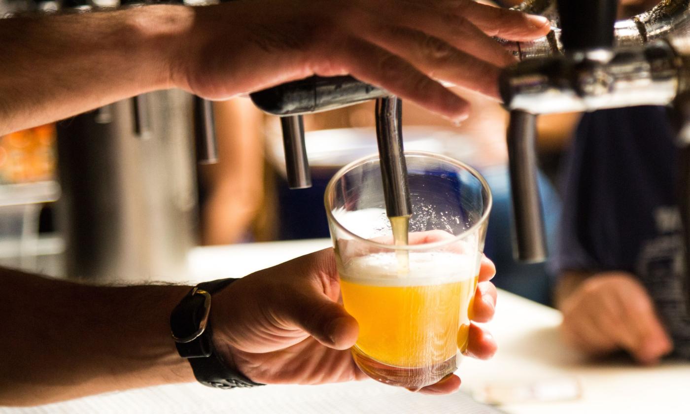 Beer spills directly from the tap.