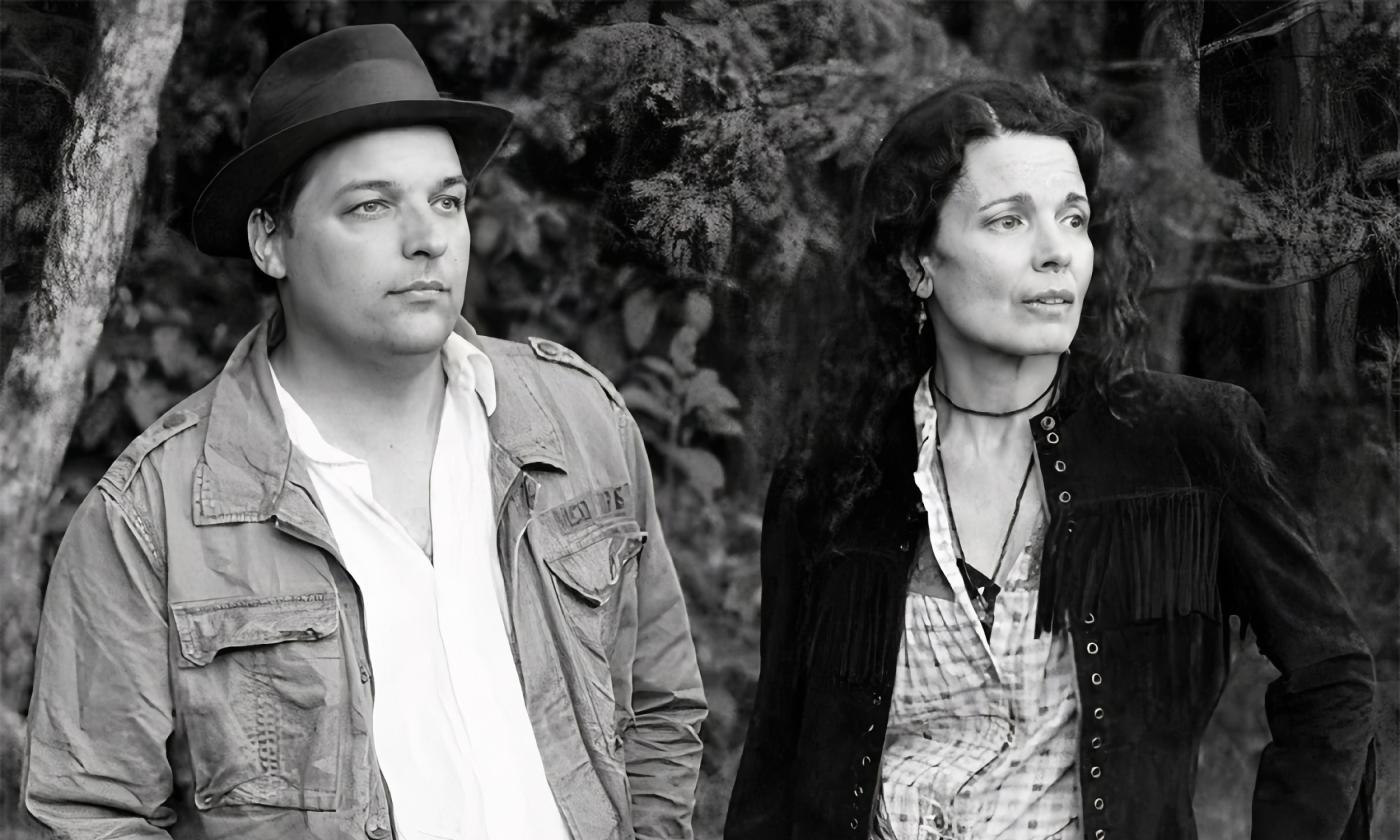 A black and white photo of the founders of the band, Donna The Buffalo, standing at the edge of a wood