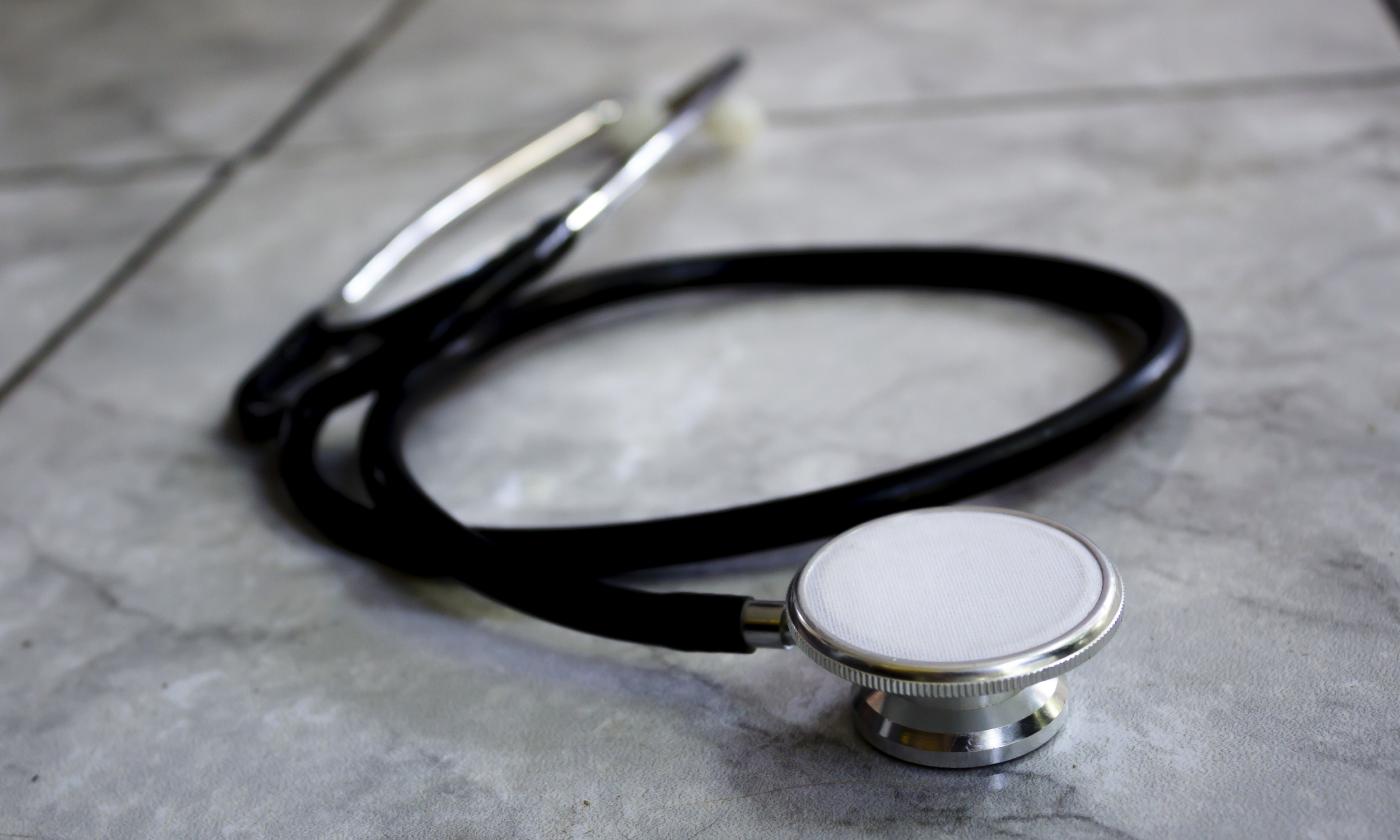 A stethoscope, laying on a marble-patterned counter