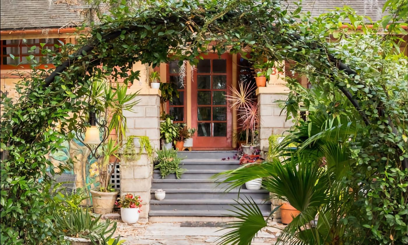 A bow of greenery at the courtyard entrance to a small inn