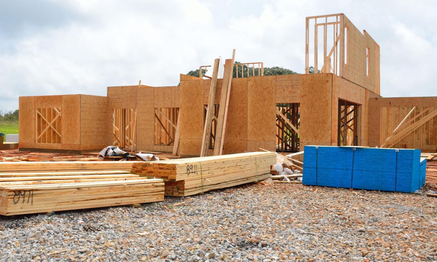 A new home under construction against a cloudy sky