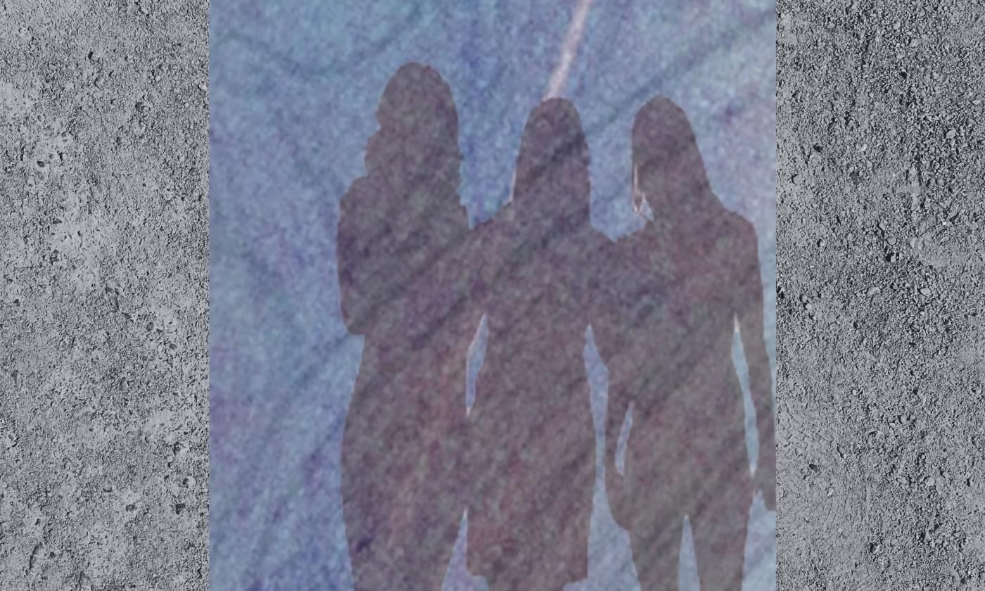 A photo of the shadows of three women against a stone wall