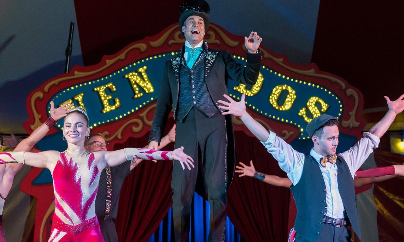 Three performers in front of Vemardos Circus Sign