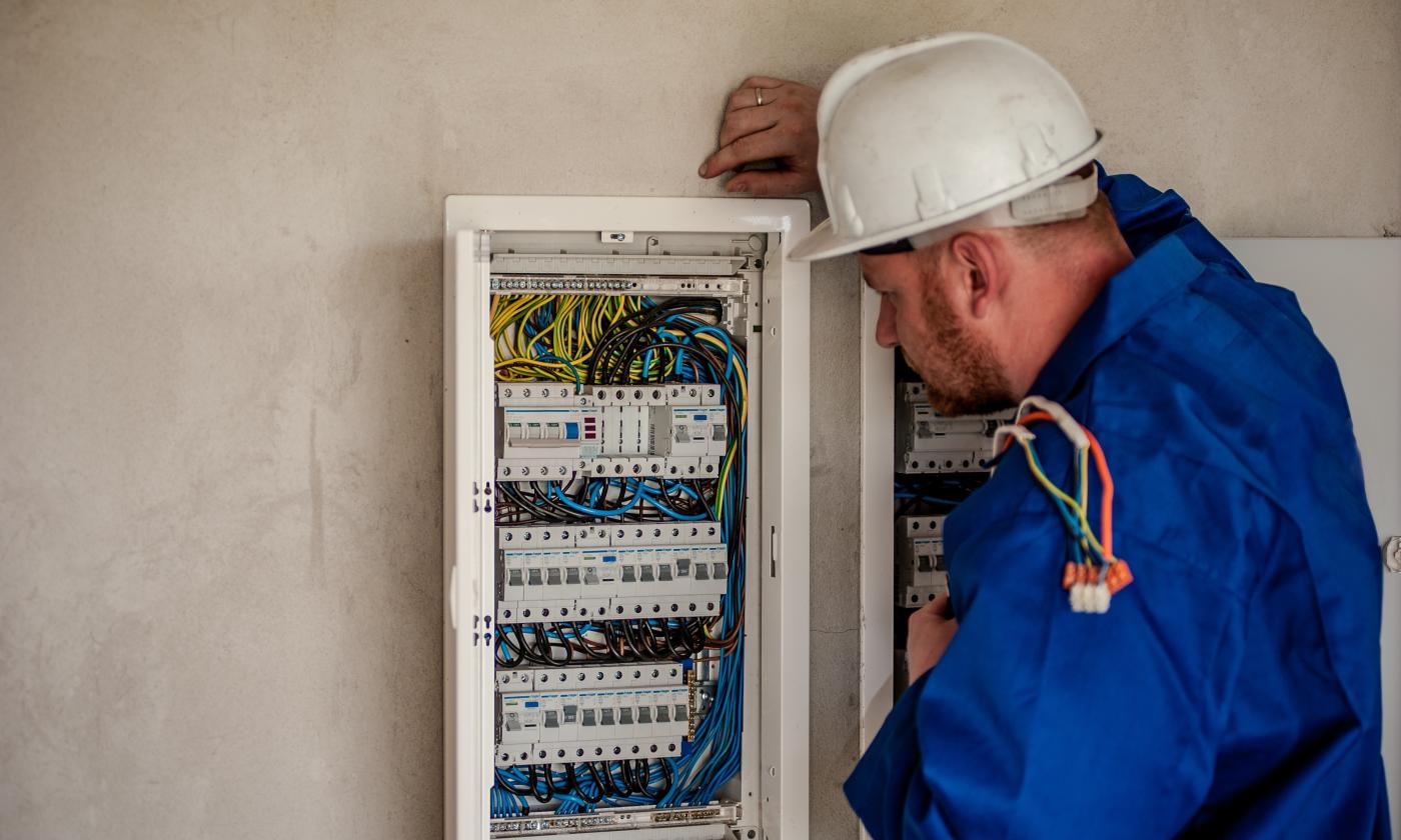 Electrician inspecting junction box.