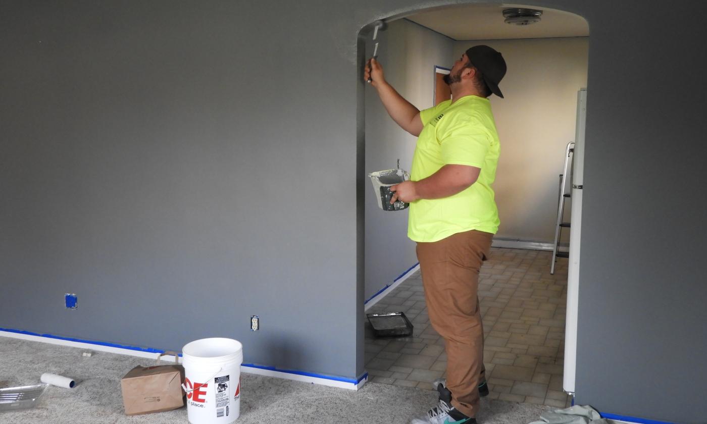 Painter working on interior doorway