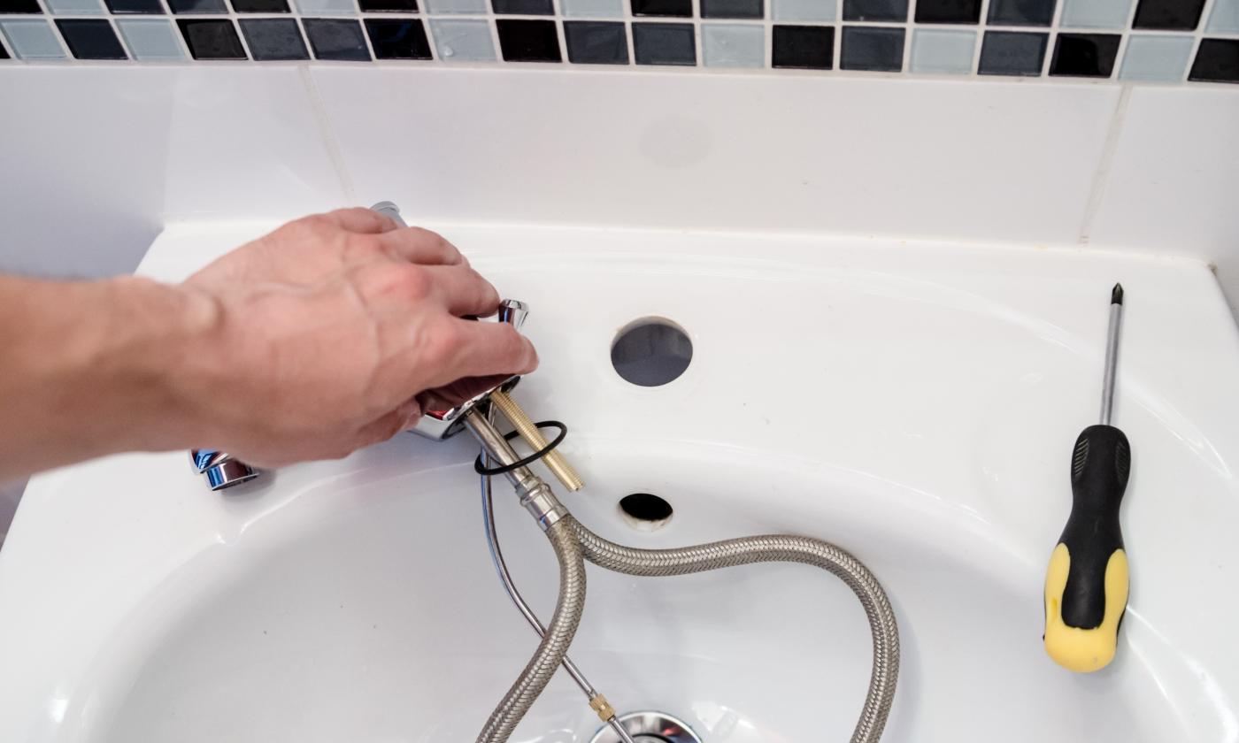 Plumber fixing sink