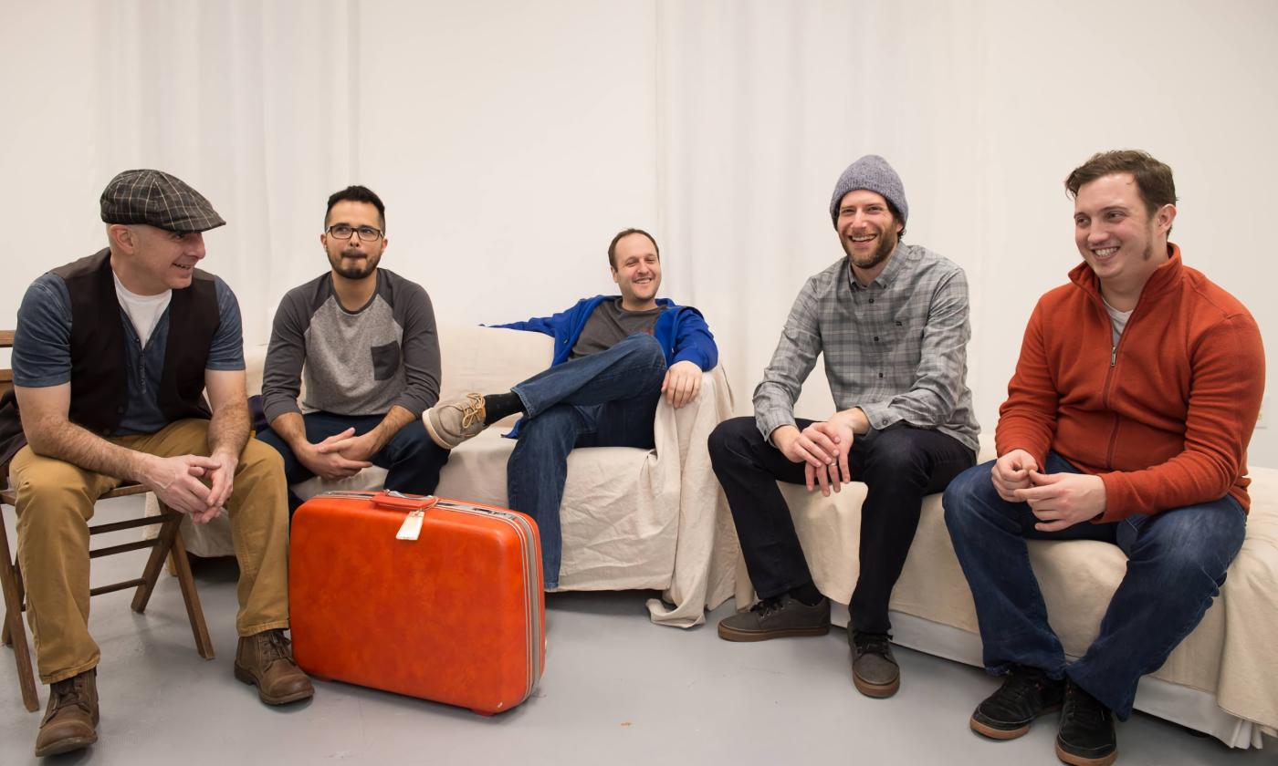 The band members of La Utica sitting in a white room