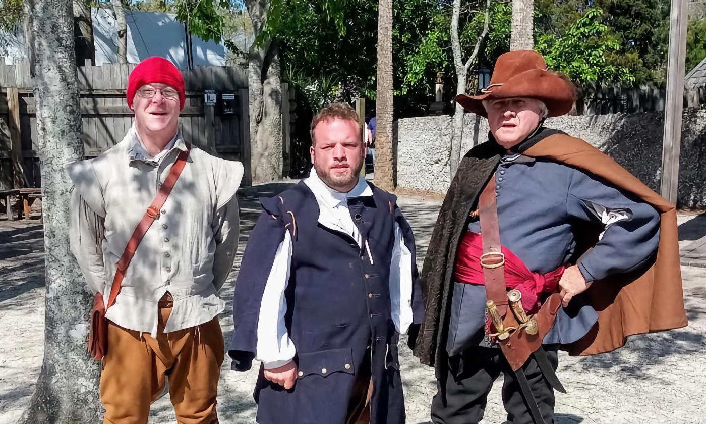 Three men, garbed in 16th century clothing and gear