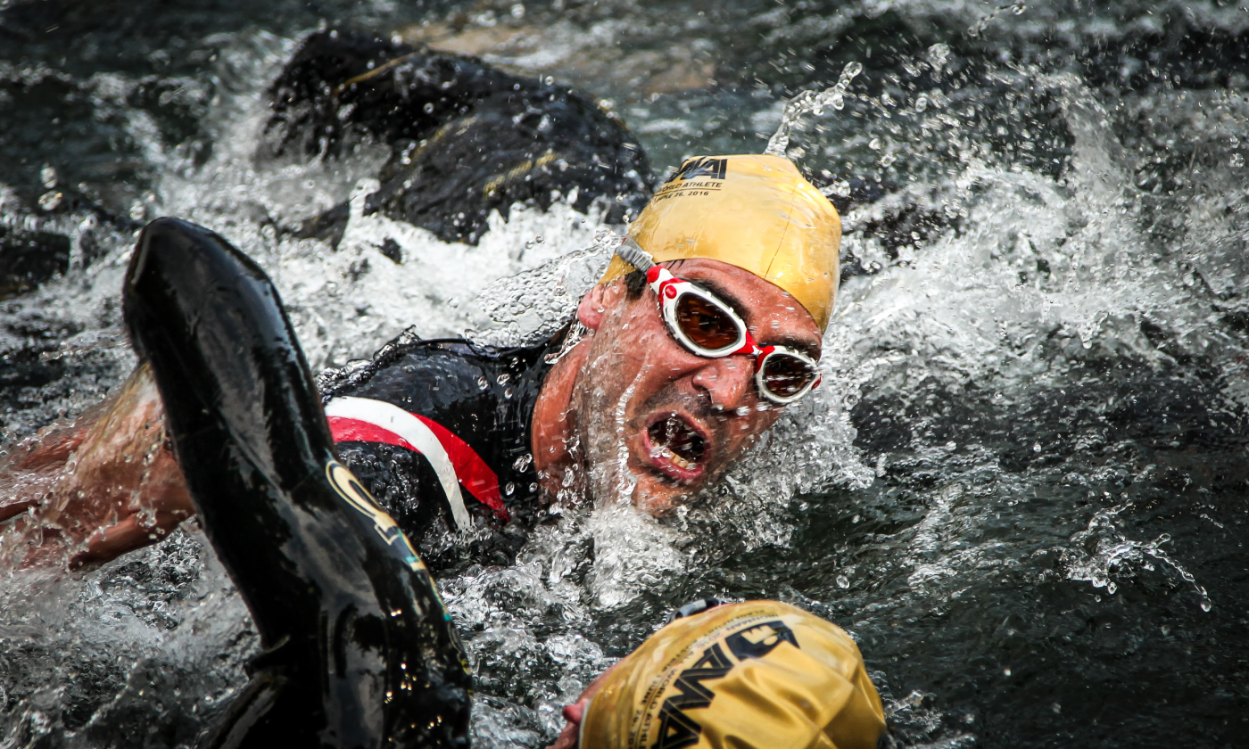 Two swimmers compete and advance towards the finish line. 