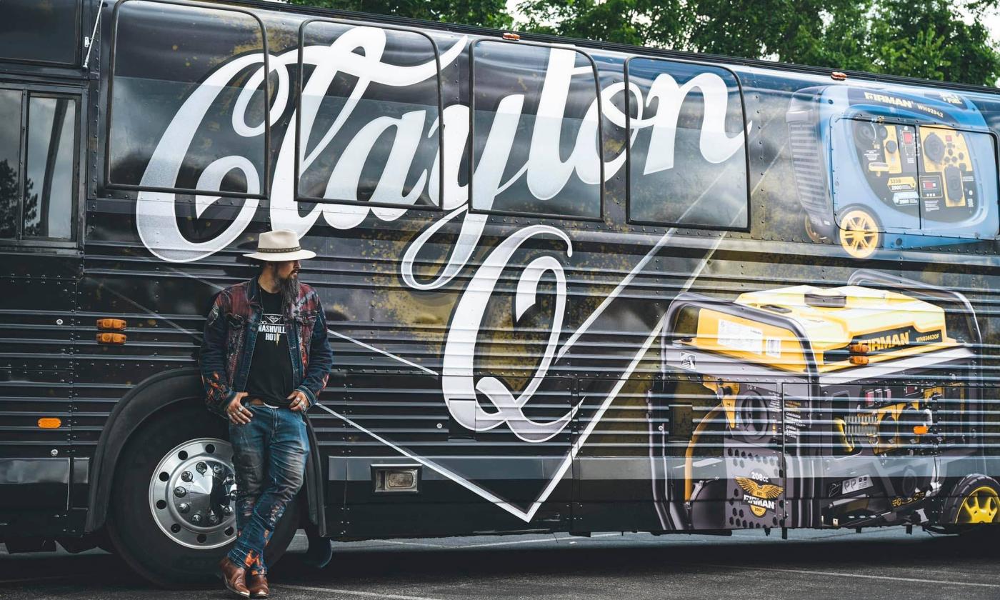 Clayton Q leans on his tour bus. 