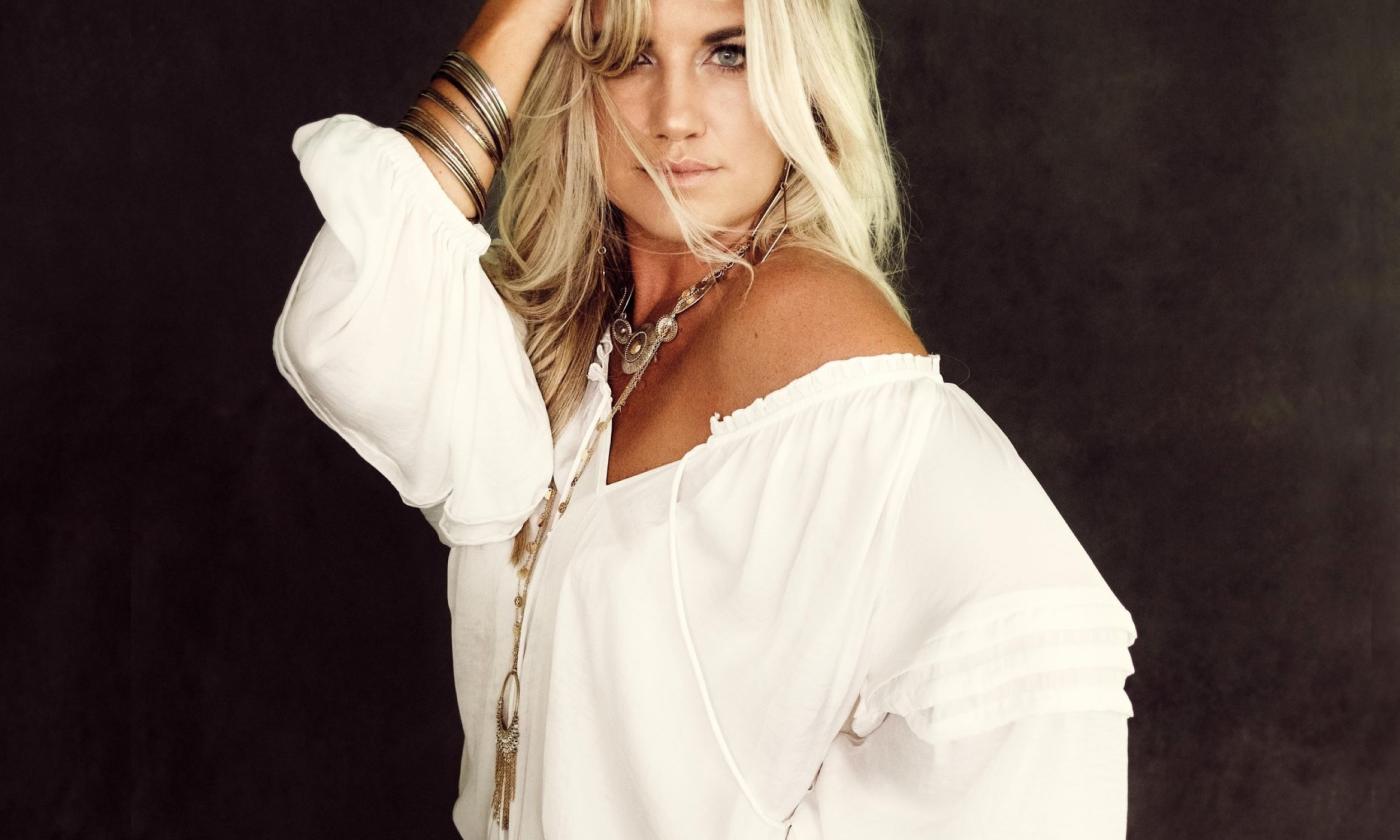 Morgan Myles smiles and adjusts her hair.