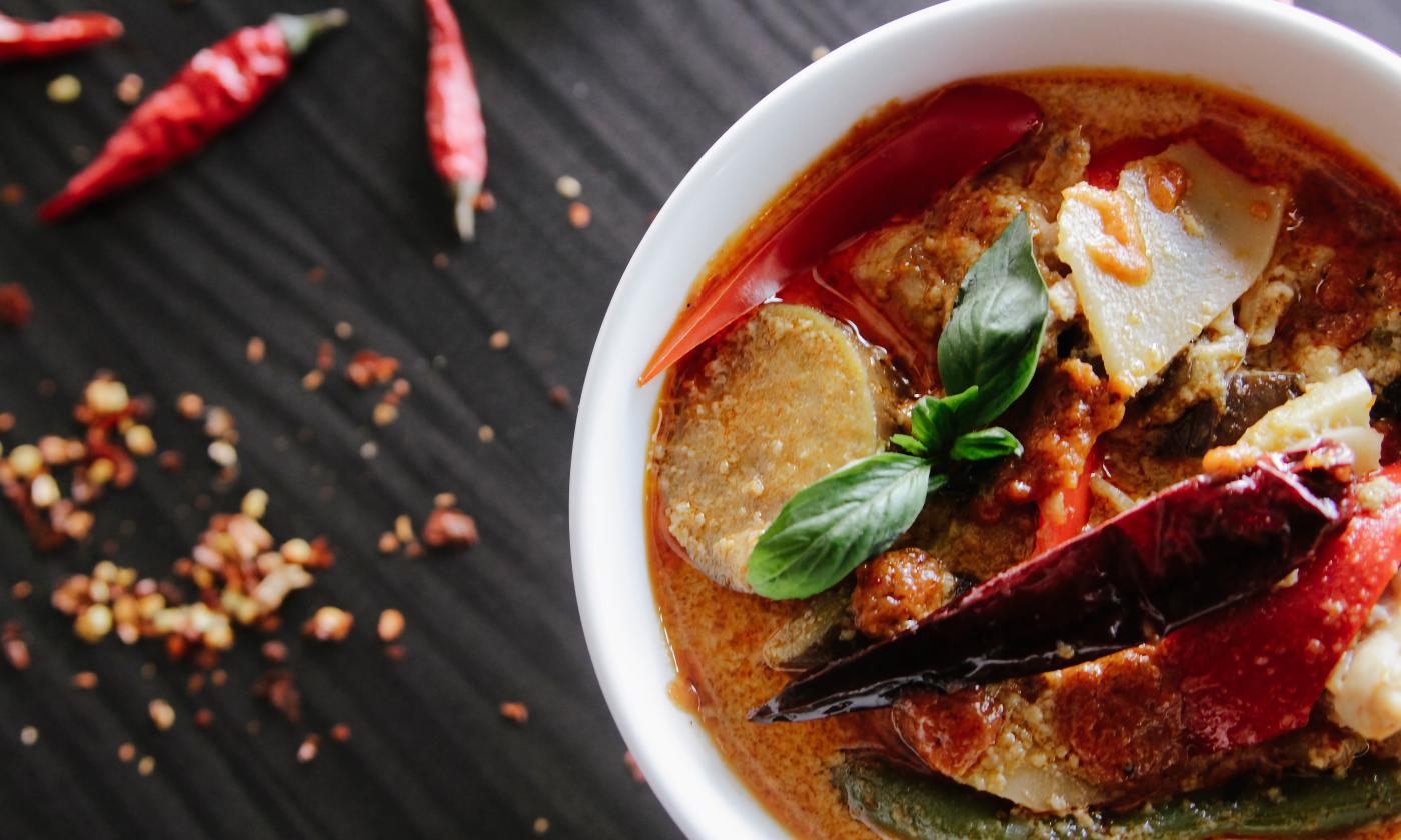 An Asian inspired soup is positioned on a table.
