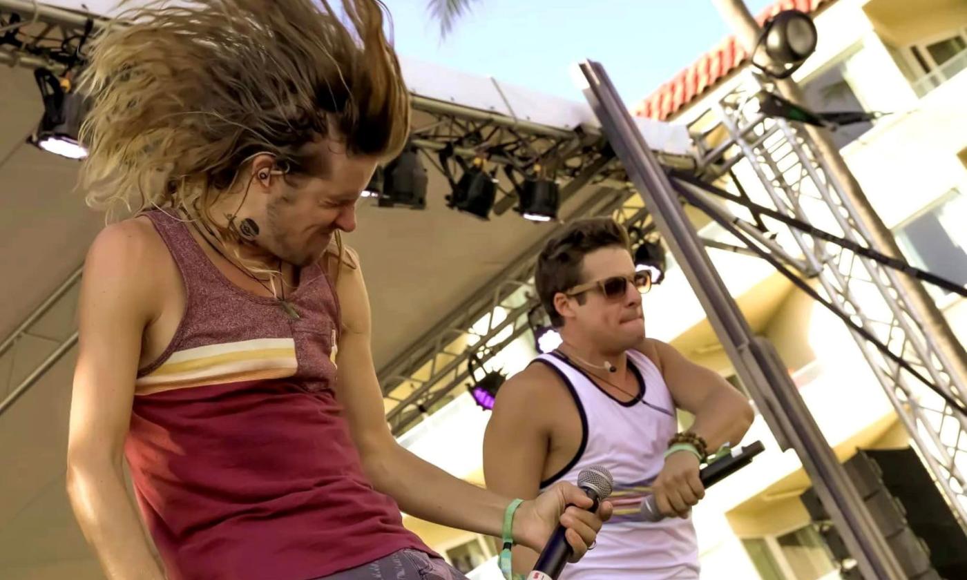 The Wheeland Brothers dance and sing on stage.