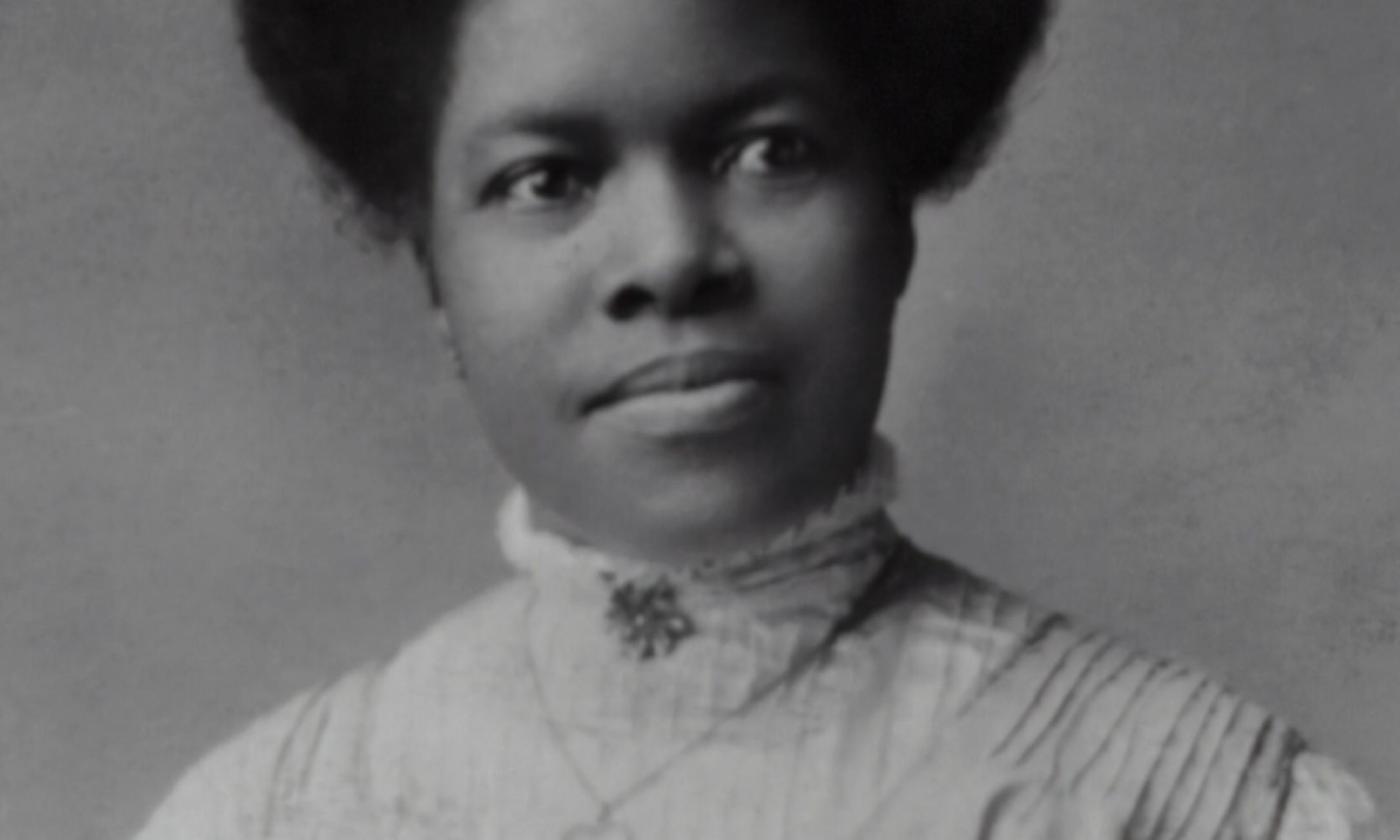 A vintage photo of an African American woman posing for the camera. 